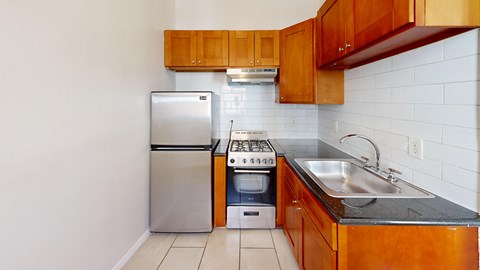 a kitchen with wooden cabinets and stainless steel appliances